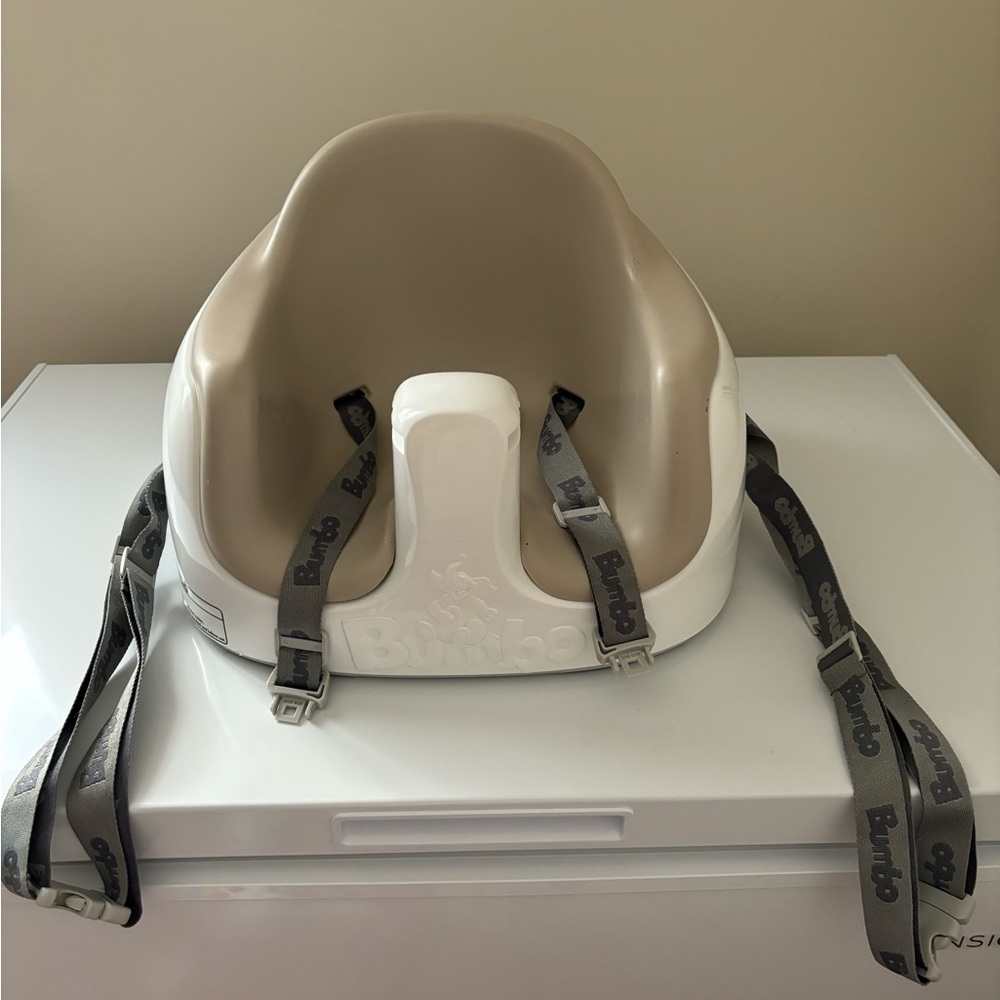 Beige Bumbo seat with tray and straps